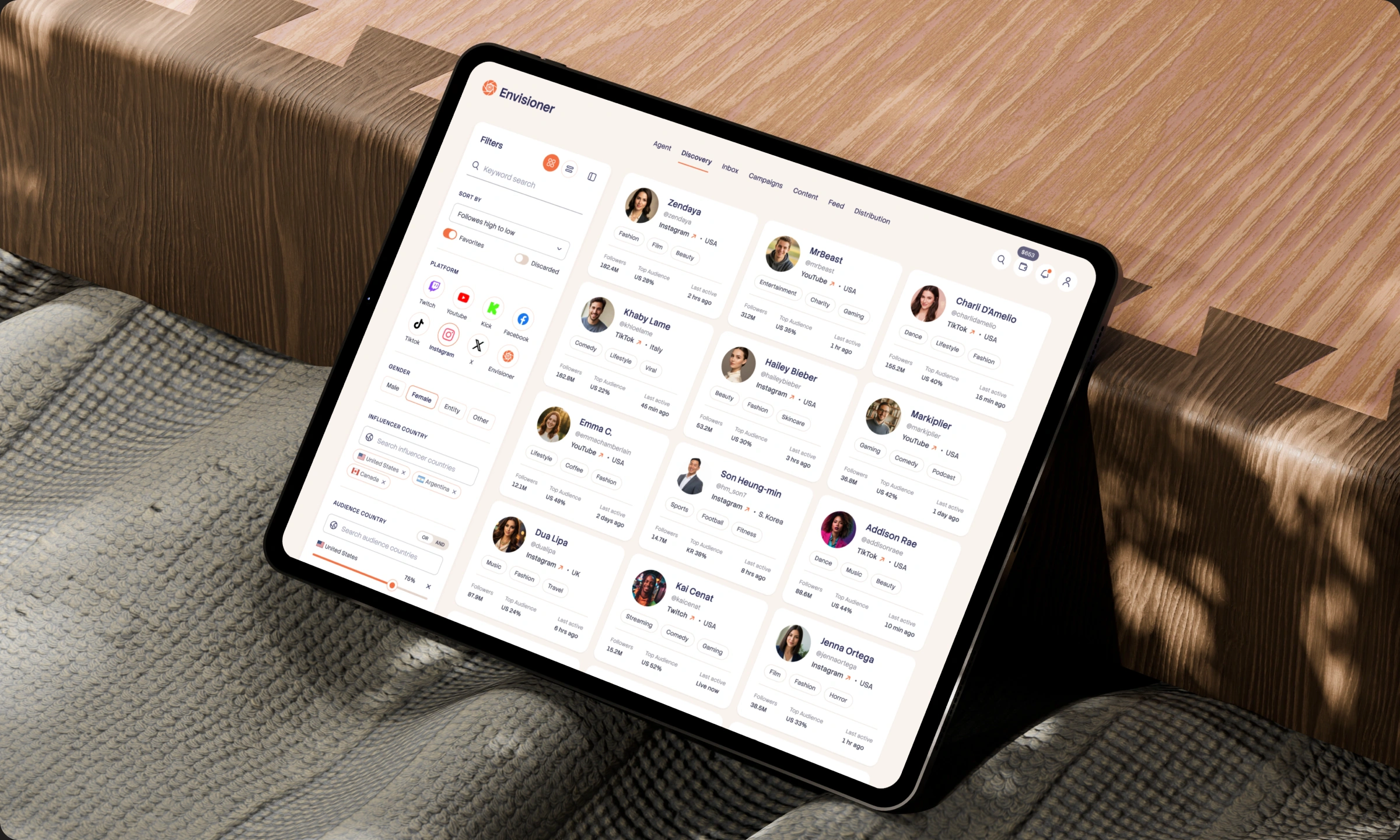 Envisioner creator discovery interface on a tablet resting on fabric and wood